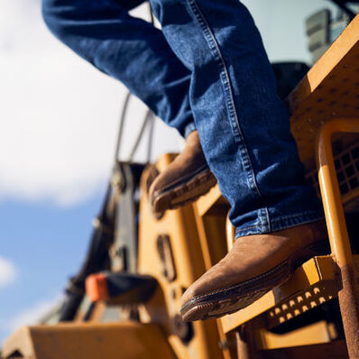 Worker stepping down machinery in Durango Maverick XP Steel Toe Waterproof Boots